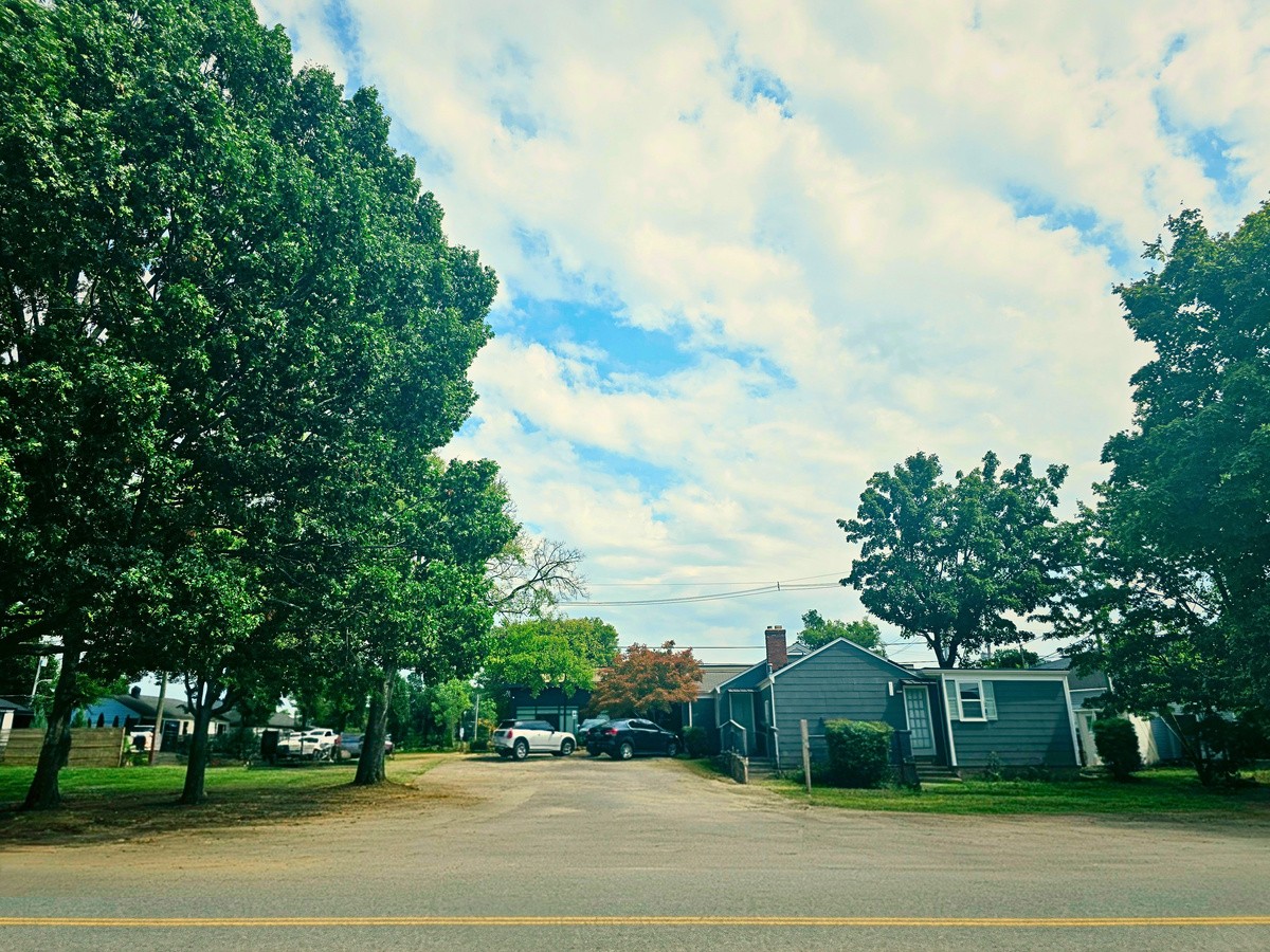 Street view of 609 W Iris Drive, a tree-lined commercial corner lot in Berry Hill
